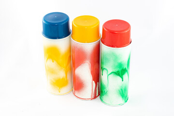 Three Colored Spray Paint Cans on White Background. Graffiti's Inventory - Close-Up Shot