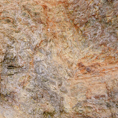 Pink granite background from layers of veined stone.
