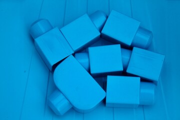 Large blue constructor elements on a blue plastic background