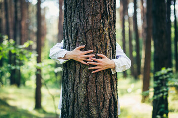Woman hugged a tree with love in the forest