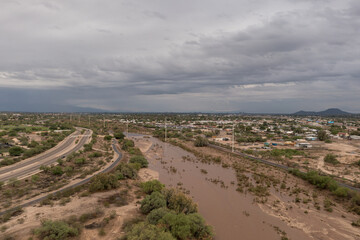 Overflowing Rillito River in Tucson after heavy rain.