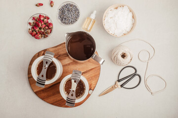 Ingredients and tools for handmade aroma candles. Organic soy wax, essential oils, wicks, pots. Craft hobby, small business, artisan products concept