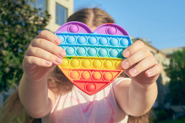 popit in the hands of a toy antistress simpldimple heart