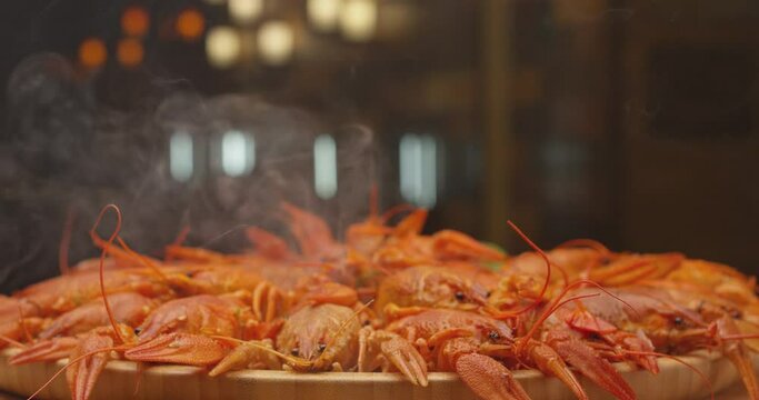 River boiled crayfish a good snack to beer. Waiter puts on the table a plate of boiled red river cancer . A plate of  fuming or smoking hot crawfish in the restaurant. Shot on RED Camera Slow motion. 