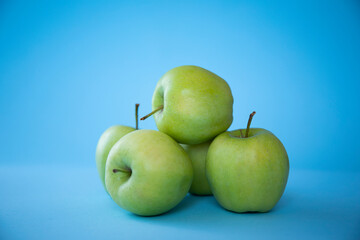 green apples on blue background