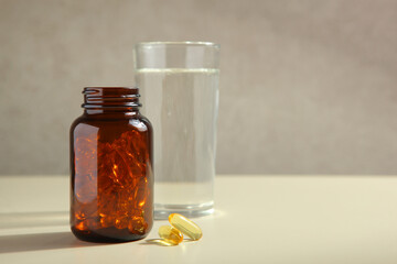 Omega 3 capsules on the table close-up with place for text.