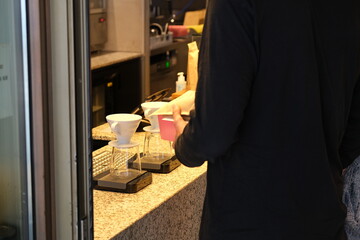 person ordering coffee in a cafe