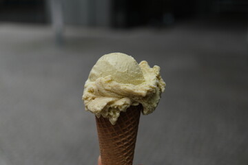 ice cream with pistachio flavor in a waffle cone