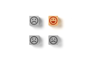 Emoticon faces concept. Black and white sad. In color is happy. The one, election the best. Flat lay photo