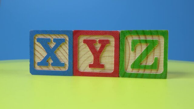 Wooden block in alphabet XYZ rotate. Child education learn concept