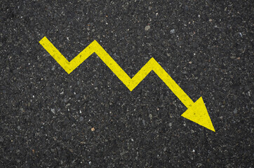 Asphalt with a yellow zigzag arrow sign pointing downwards to the right. Tarmac road with a zigzag...