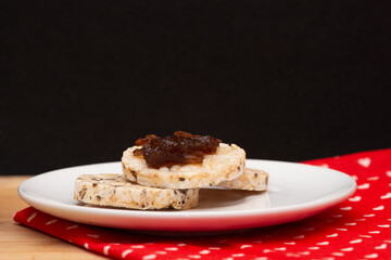 close up of a plate with rice vegan cookies with  jelly on the top