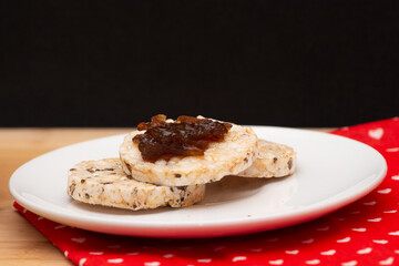 close up of a plate with rice vegan cookies with  jelly on the top