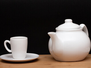 cup of coffe  and a coffee pot  under the wood table