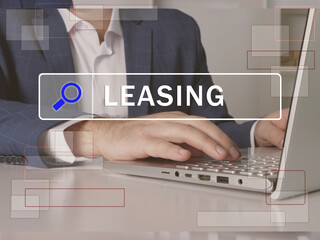  LEASING phrase on the screen. Broker use internet technologies at office. Concept search and...