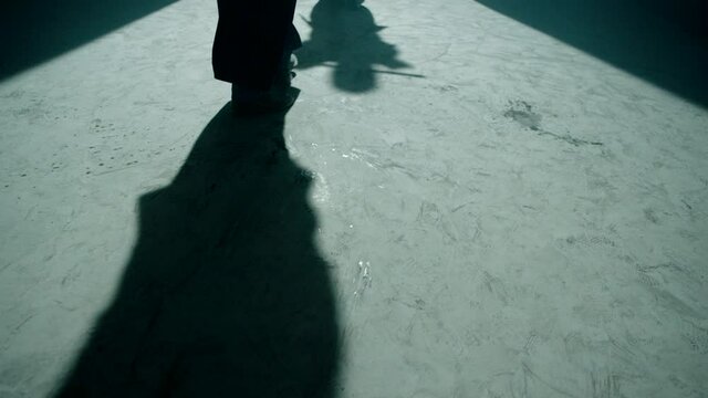 Shadow in floor of Japanese kendo fighters with bamboo swords competing in dark mystic industrial building. Epic battle video with two kendo fighter . Shot on ARRI Alexa Cinema Camera in slow motion .