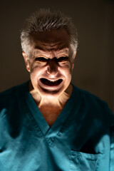 Photo of an old evil haunted doctor with a scary facial expression