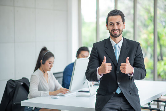 Boss or manager stand and show thump up happy ,background customer service or telemarketing