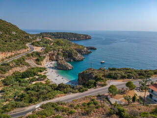 Aerial view of the famous rocky beach Foneas near Kardamyli village in the seaside Messenian Mani area during high tourist Summer period. Messenia, Peloponnese, Greece.