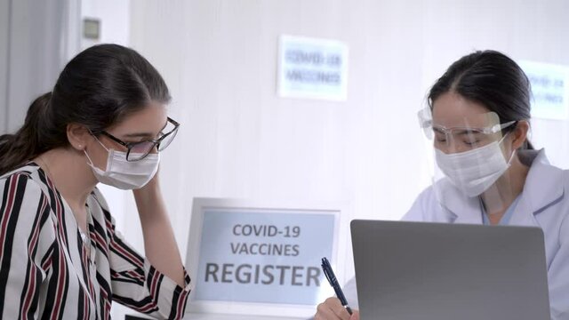 woman register to get covid vaccine in clinic or hospital. female wearing protective mask against covid-19.