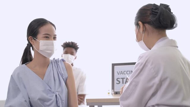 Portrait of woman getting covid vaccine in clinic or hospital, with hand nurse injecting vaccine to get immunity for protect virus. teenager wearing protective mask.