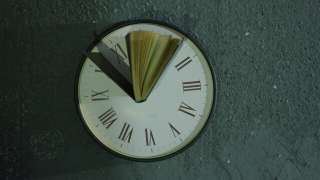 Book's pages turning by wind on 24 hours antique clock with classic roman numerals . Wind browse pages of old historic book . Mystical , abstract and symbolically video. Shot on ARRI Alexa camera .