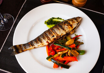 Fried sea bass with vegetables and mushrooms. High quality photo