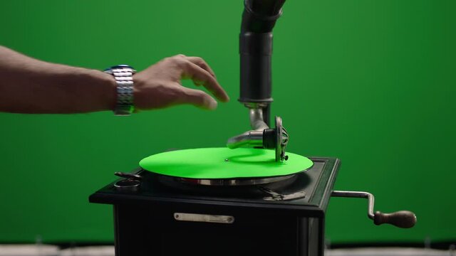 Vintage gramophone . Vintage old gramophone plays a vinyl record on green screen background . Wooden case turntable . Vinyl phonograph . Shot on ARRI ALEXA Cinema Camera in slow motion .