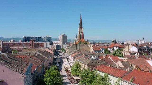 Street Market And City Buildings With Name of Mary Church In Novi Sad, Serbia. - aerial