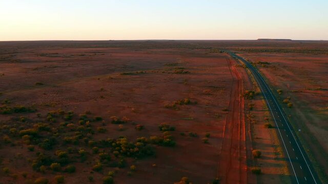 Stuart Highway In Middle Of Desert At Sunset In South Australia. - aerial
