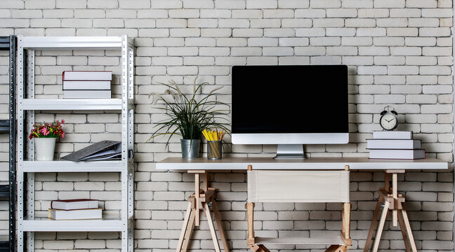 Minimal style with less decorate office coner with metal shelf, computer director chair and wooden table with brick wall background. Concept of work at home