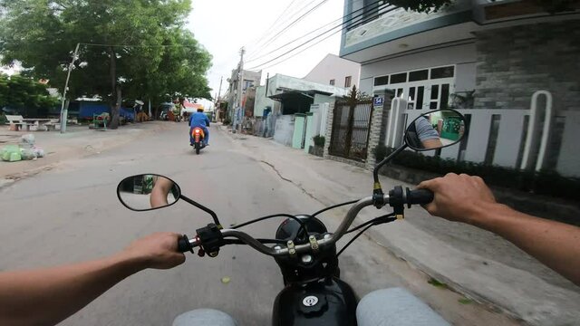 POV bike driving on the streets of MuiNe,Palm,Jungle ,Vietnam.street market city center POV . Urban city streets in residential and business sections neighborhoods. Narrow residential roads