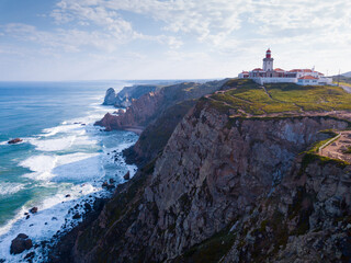 Fototapeta na wymiar Scenic aerial view of lighthouse at cape Cabo da Roca in sunny spring day, Portugal