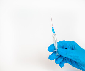 The doctor holds a vaccination syringe on a white background. A shot from the coronovirus....