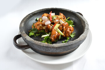 stir fried chicken meat with mala spicy sauce xiang guo in hot stone pot in white background asian halal menu