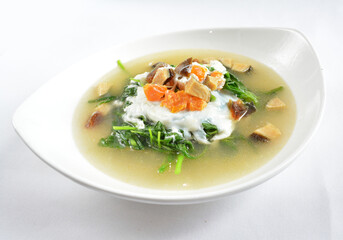 stir fried mixed vegetables spinach with 3 salted eggs in hot soup in white background asian halal...
