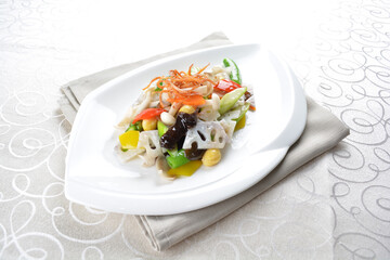 stir fried mixed vegetables with lotus root and seed in soy sauce in white background asian halal menu