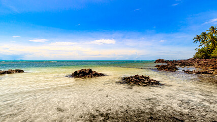 rock inside beach with nice sky