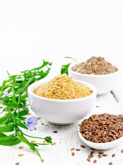 Bran and flour flaxseed in bowls on white wooden board
