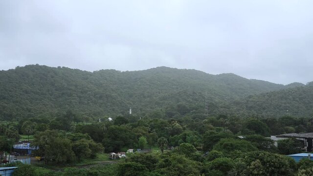 timelaps of cloudes moving over green mountain  in rainy seson .