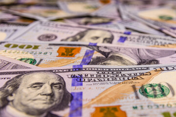 Background of one hundred dollar banknotes. Selective focus