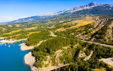 Fototapeta na wymiar Panoramic scenic view of Serre-Poncon Lake and Alps in southeast France