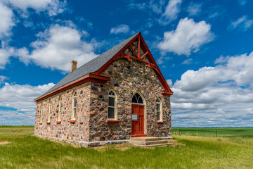 Fototapeta na wymiar The historic stone Fairview United Church, built in 1903, and surrounding countryside, outside Regina, SK
