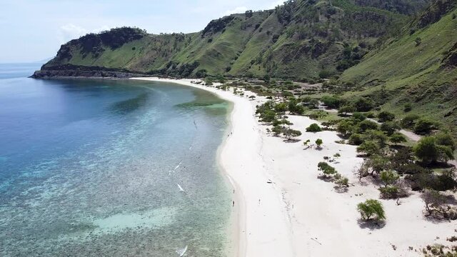 Aerial Drone Of People, Adults, Children, Kids Walking On Secluded, Remote Beach On Tropical Island Timor Leste, South East Asia