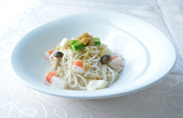 braised seafood bee hoon thin rice noodle in opeh leaf in white background asian halal menu