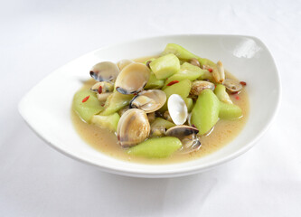 stir fried clam shell seafood with luffa plant vegetable in spicy sauce in white background asian...