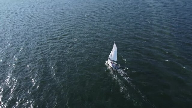 Sailboat Sailing in seawater by coastline in Massachusetts