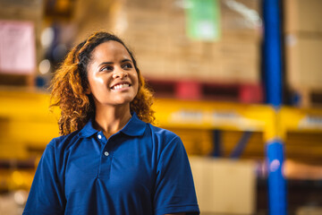 African American woman are work with business distribution inventory in warehouse factory, female people working in safety occupation job for shipping industry manufacturing