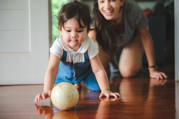 Fototapeta premium young mother are happy to raising new little children at home, woman family with newborn baby who son or daughter, love and care motherhood people, holding small cute girl