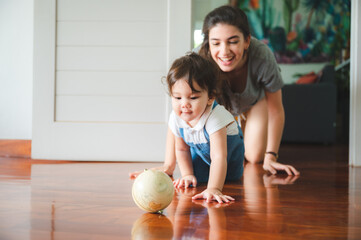 Fototapeta premium young mother are happy to raising new little children at home, woman family with newborn baby who son or daughter, love and care motherhood people, holding small cute girl